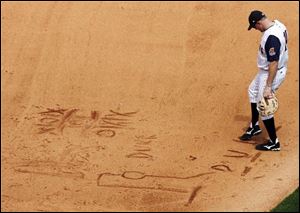 Chris Maples adds letters to a game of 'hangman' started by the Clippers' Larry Broadway and umpire Jamie Roebuck. 