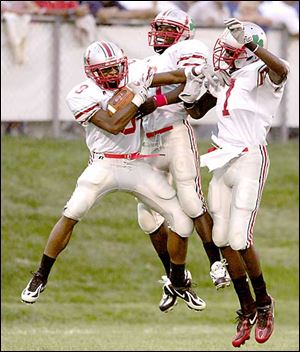 Central's Cedric Bouyer (8) celebrates his 76-yard touchdown reception with Donte Johnson (7) and Vyshawn Arnold.