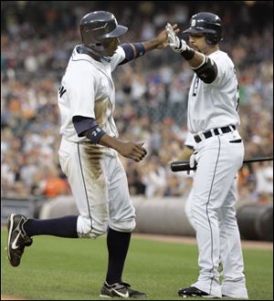 Tigers leadoff hitter Curtis Granderson is congratulated by designated hitter Gary Sheffield after scoring in the first inning.