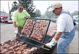 Gene Palmer and Lee Myers man the grilling pit.