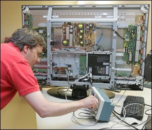 Jeff Guy runs tests on a flat-panel display at Imaging Systems Technology Inc., a Toledo company that received state grants in 2004 and 2005 totaling nearly $800,000.