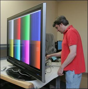 Jeff Guy runs tests on a flat-panel display at Imaging Systems Technology Inc., a Toledo company that received state grants in 2004 and 2005 totaling nearly $800,000.