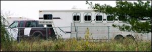 The trailer in which four people from Tomah, Wis., died of carbon monoxide poisoning is parked at the Alliant Energy Center in Madison, Wis. Friday, Oct. 12, 2007. Carbon monoxide from a portable gas heater likely killed four people, including two children, as they slept in a combination camper-horse trailer ahead of a horse show