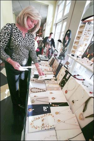  Sandi Sydlowski of holland looks over Amberardo  (amber) jewelry