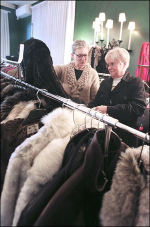 Sara North of Perrysburg, from left, and Dottie Wilkerson of Sylvania look over coats that were on sale.