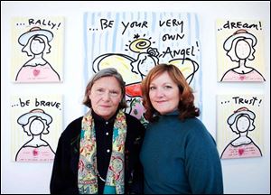 Artist and activist Nancy Swan Drew, left, poses in front of her artwork with Kathie Kolodgy during the Be Your Own Angel Soiree at the MMK Gallery.