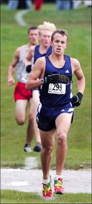 Joe Miller of St. John s leads the pack in the City League cross country meet at Ottawa Park. The senior won with a time of 15:23.27 to place first for the second straight season.