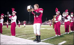 Toledo Central Catholic football player and trumpet player Thomas Dysard performs with other members of the band at halftime