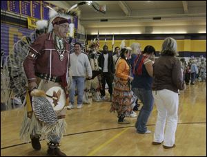 Shane Norris of Newark, Ohio, left, leads a line of dancers.