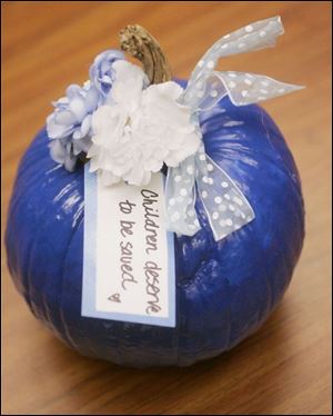 Gust Brothers Pumpkin Farm in Ottawa Lake donated 20 of the pumpkins that Abbey Pawiak painted and tied with a bow.