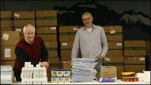 The Rev. Roger Miller, left, and the Rev. Tom Schaeffer prepare to assemble caregiver kits for HIV/AIDS sufferers.
