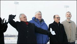 The first pitch is a snowball from Mayor Tony Iriti. From left, councilmen Mike Slough, Andy Peters, and Mike Eler watch.