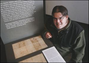 Dan Woodward, an education specialist at Fort Meigs, shows the display case where the letters of William Johnson are on exhibit. 
Johnson was a soldier who survived Dudley's Massacre in 1813 in what is today Maumee.

