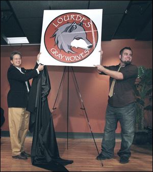 Lisa Binkowski, director of student activities and recreation, and art student Luke Ellison present the mascot he designed for the school. The wolf is part of the Franciscan tradition in which Lourdes is rooted. Russell J. Ebeid, president of Guardian Industries Glass Group, speaks at the dedication of the Ebeid Student Center in Delp Hall.