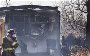 Crews work at Carriage Way Mobile Home Park on Telegraph Road where a man died in a blaze he is thought to have set.