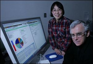 Bowling Green State University biologists Zhaohui Xu, standing, and Paul Morris say computer comparisons will be key for students studying the bacteria in the federal research project.