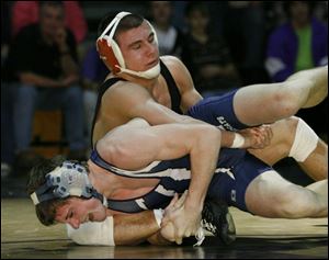 Oak Harbor s Kirk Tank controls Napoleon s Lee Drummond in the 152-pound final at the Perrysburg Invitational. Tank (36-4), a state runner-up last season, will wrestle at Michigan State.