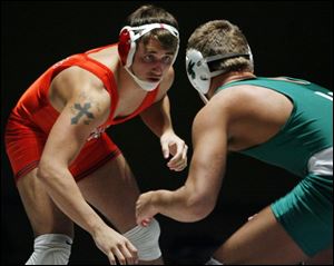 Oak Harbor s Cody Magrum, a two-time Division II state champion, prepares to take on Medina Highland s Ted Bodnar. The189-pound senior, who has a 36-1 record this season with 26 pins, will wrestle at Ohio State.