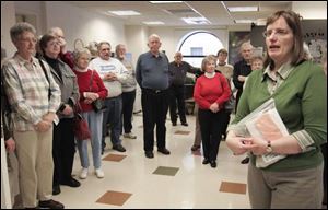 Brenda Ransom, who is the records manager for Wood County, guides about 50 budding and seasoned genealogy enthusiasts on a tour of the Wood County Chapter of the Ohio Genealogical Society through the records center in Bowling Green. During last week's tour, the participants were shown that a wealth of information can be found right in their backyard, whether it's gleaned from a dusty, fragile ledger or on microfilm.