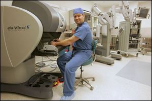 Dr. Andrew Croak, a urogynecologist, works with the da Vinci robotic surgical system at St. Luke's Hospital. Such systems are in place at three other hospitals in the area.