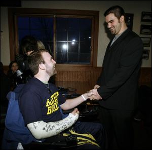 Brock Mealer greets brother Elliott just before the Wauseon standout signed his letter of intent yesterday in Ann Arbor.