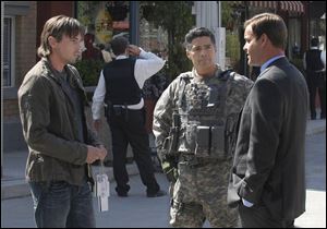 Jake Green (Skeet Ulrich, left) and Maj. Edward Beck (Esai Morales, center) talk to an unidentified bureaucrat about the new government of the Allied States of America.