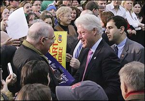 Former President Bill Clinton greets the crowd at the University of FIndlay's Croy Physical Education Center today.