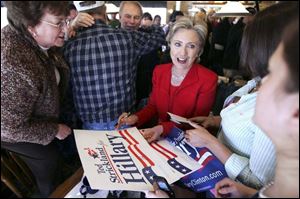 Sen. Hillary Clinton campaigns in Rio Grande, Ohio, during
her swing through southern Ohio. Joining her is Gov. Ted
Strickland, embracing a supporter in the background.
