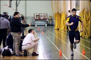 Offensive lineman John Greco of the Rockets is timed by NFL scouts as he runs the 40-yard dash at the University of Toledo.