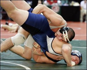 Central Catholic s Dave Pickerel is in control of his match with Nick Thompson of Tallmadge. Pickerlel won a 4-2 decision.
