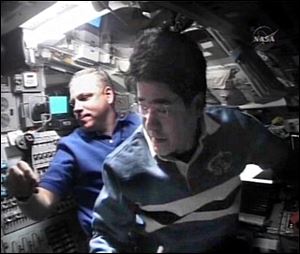 In this image from NASA TV, Japan Aerospace Exploration Agency astronaut Takao Doi, right, is seen on the flight deck of shuttle Endeavour with pilot Gregory Johnson on Tuesday.
<br>
<img src=http://www.toledoblade.com/graphics/icons/video.gif> <b><font color=red>AP VIDEO</b></font color=red>: <a href=