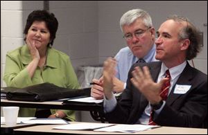 Michael Beazley, right, asks a question of Lt. Gov. Lee Fisher as Tina Skeldon Wozniak, left, and Timothy Pedro listen.
