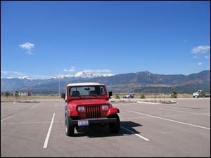 The columnist's Toledo-made Jeep in its retirement city, with the Rocky Mountains as a backdrop.