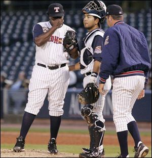 Toledo pitcher Anastacio Martinez, left, catcher Dane Sardinha and pitching coach A.J. Sager met in sixth for some strategy.