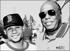 Former Mud Hen John Young, right, beams as he meets with one of his RBI graduates - Red Sox outfielder Coco Crisp.