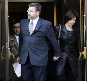 In this October 2007 photo, Davis Besse trial defendents leave Federal Courthouse after verdict. From left: attorney Andrew Wise, David Geisen and his wife, Kathy, exiting courthouse