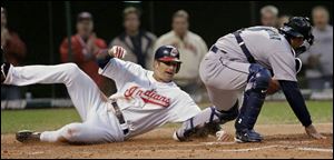 The Indians' Casey Blake tries unsuccessfully to avoid a tag by Mariners catcher Kenji Johjima.