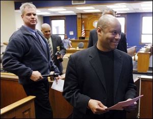 Richard Brown, right, leaves Lucas County Common Pleas Court after sentencing.