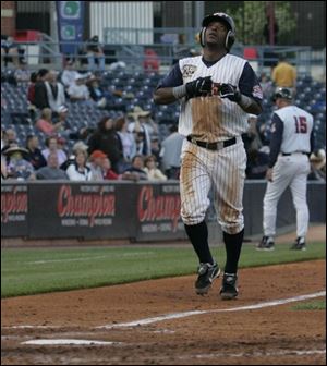 The Hens  Timo Perez looks skyward before crossing the plate after hitting a home run. He went 4-for-4, including a triple.
