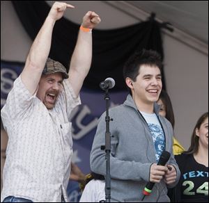 American Idol contestant David Archuleta, and his father, Jeff Archuleta, celebrate before a performance at David's high school Friday in Murray, Utah. 