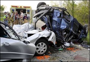 Rescue crews survey the scene of a crash in West Springfield,
Pa. Six of seven people were killed when a minivan crashed
near the Ohio-Pennsylvania border.
