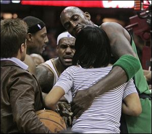 Boston Celtics' Kevin Garnett, right, holds Gloria James after she came out of her seat following a foul on Cleveland Cavaliers' LeBron James, back center, by Celtics' Paul Pierce, back left, in the second quarter of Game 4 of the NBA basketball Eastern Conference semifinals on Monday in Cleveland.