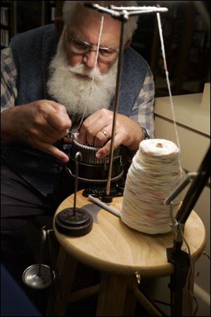 NBRN lost15p  Harry Schroeder, of Temperance, hangs the hem of a sock using a sock knitting machine which he says is 80 years old.  The Monroe County Library System presents Lost Arts IV, with demonstrations of arts from the past, at the Bedford branch of the  library in Bedford, Michigan on May 10, 2008. Exhibits include woodcarving, weaving, quilting, spinning, etc.  The Blade/Jetta Fraser