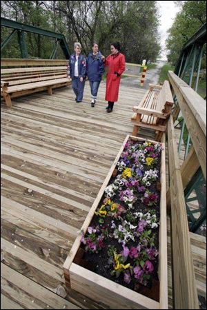 Edie Olds, Kelli Keins, and Christie Raber, Wood County Historical Society director, walk across the Linwood Road pedestrian bridge.