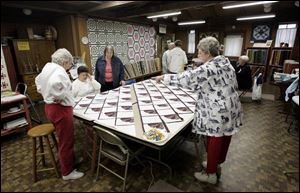 Members of The Quilt Foundry Guild, in the foreground from left, Joan Moulton, Karen Rupp, Darlene Gromes, and Alice Strieter, work in the Buttergilt Building in Maumee