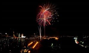 As seen from the Anthony Wayne Bridge, fireworks explode over the Maumee River to mark the Fourth of July.
