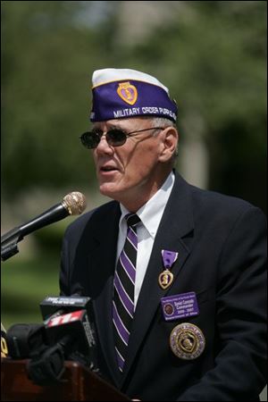 Military order of the Purple Heart Commander Daniel Cannode of Waterville Township addresses attendees.