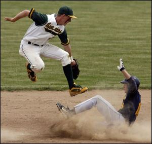 Joseph Dorocak of Cleveland St. Ignatius steals second base in the fifth inning as Start's Aaron Newman goes airborne.