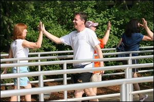 As part of a club tradition, Sir Andy and Ms. Boggis high-five as they pass one another in line for a roller coaster at Cedar Point in Sandusky, Ohio. 