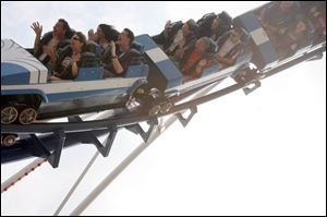 Roller Coaster Club of Great Britain members, front car clockwise from left, Sir Andy Hine, Christine Hine, Barry Healey, and Lisa Marshall ride the Corkscrew at Cedar Point. Debra Boggis and Alan Chilvers are in the front seat of the second car. 